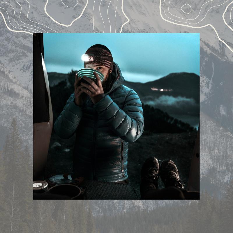 man packing backpack wearing insulated jacket