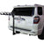 A white SUV with a Saris Grand Slam 4 Bike Hitch Rack, made of durable steel and featuring a tilting base for easy access, is mounted on the trailer hitch. The bike rack is empty in the image.