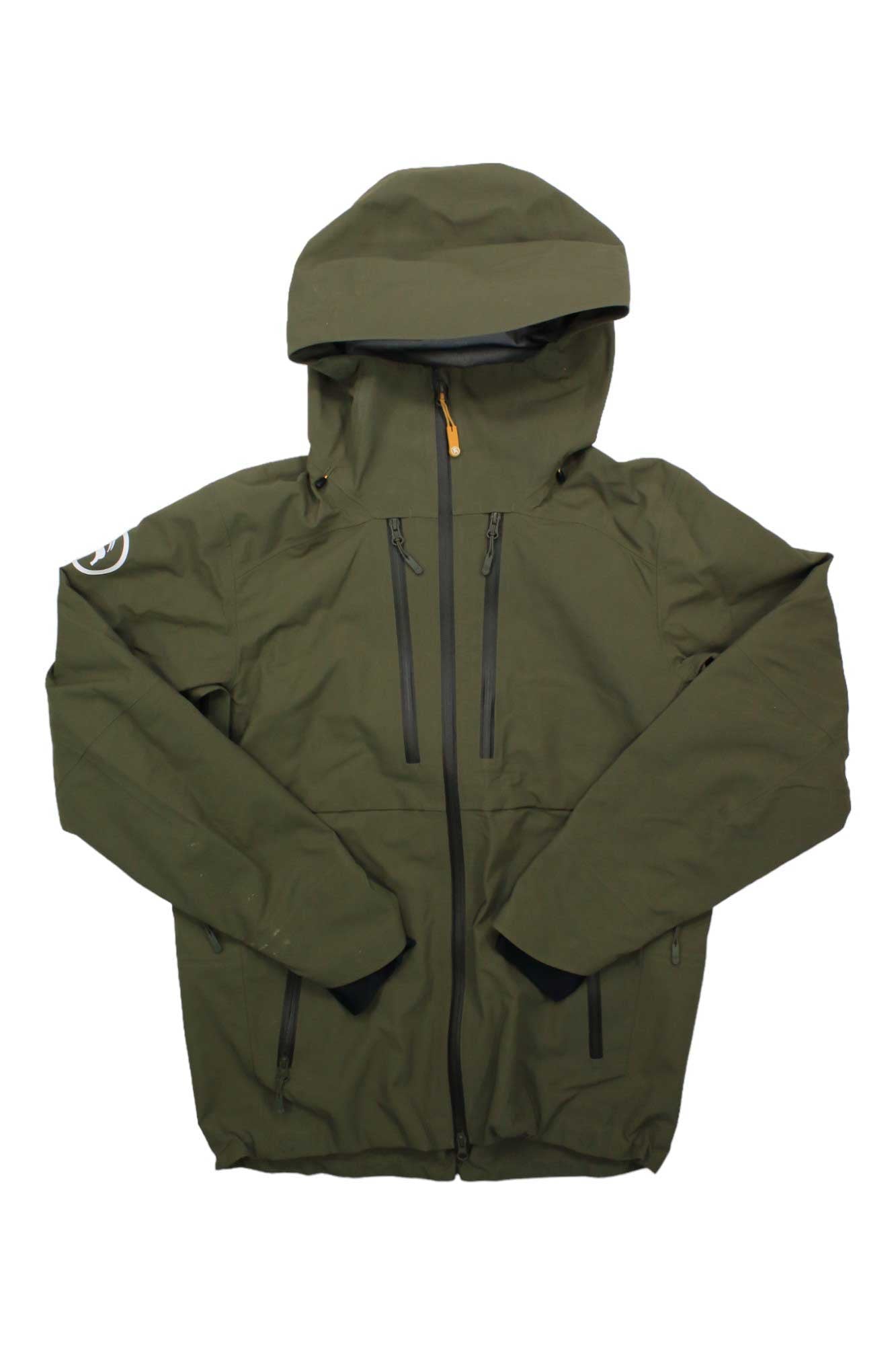 The Backcountry Cottonwoods Jacket, a weather-resistant men's shell in olive green with a hood, front zipper, two vertical chest pockets, and a left sleeve logo patch, is displayed flat on a white background.
