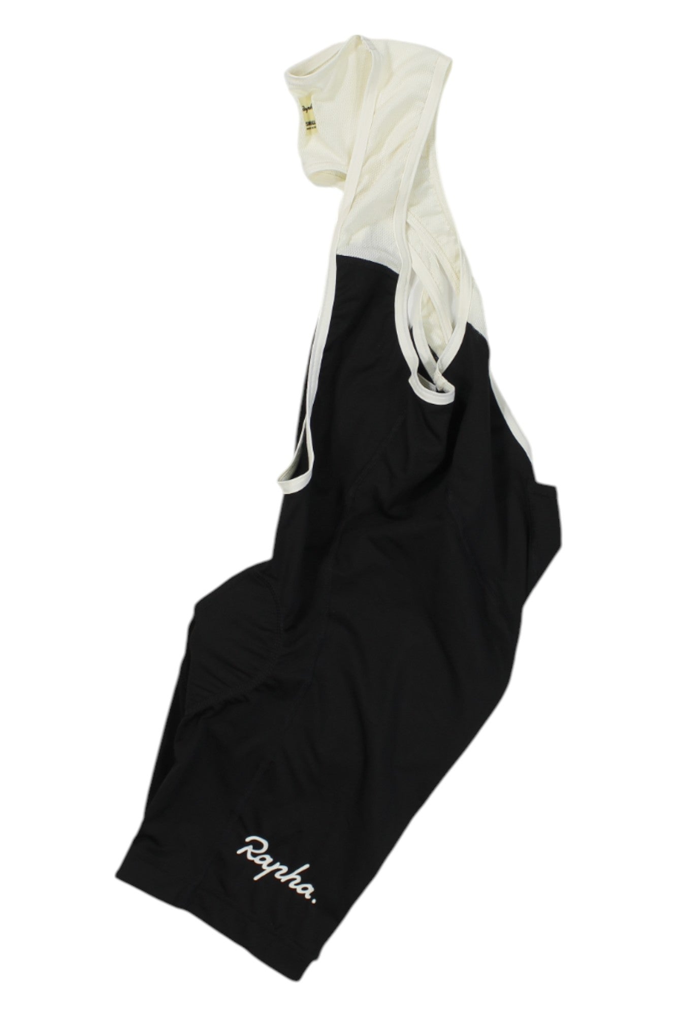 The Rapha Classic Bib Shorts II, in black and white with the logo on one leg, feature comfortable shoulder straps and recycled fabric—shown laid flat on a white background. Ideal for road cycling.