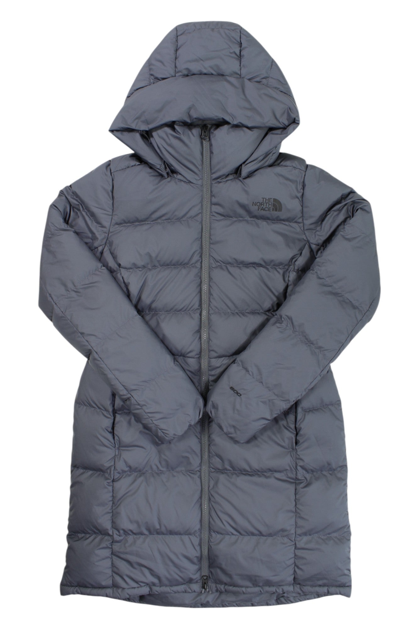 The Womens Metropolis Parka is a long, gray hooded puffer jacket with a front zipper, quilted design, 550 fill goose down insulation, and The North Face logo on the chest.