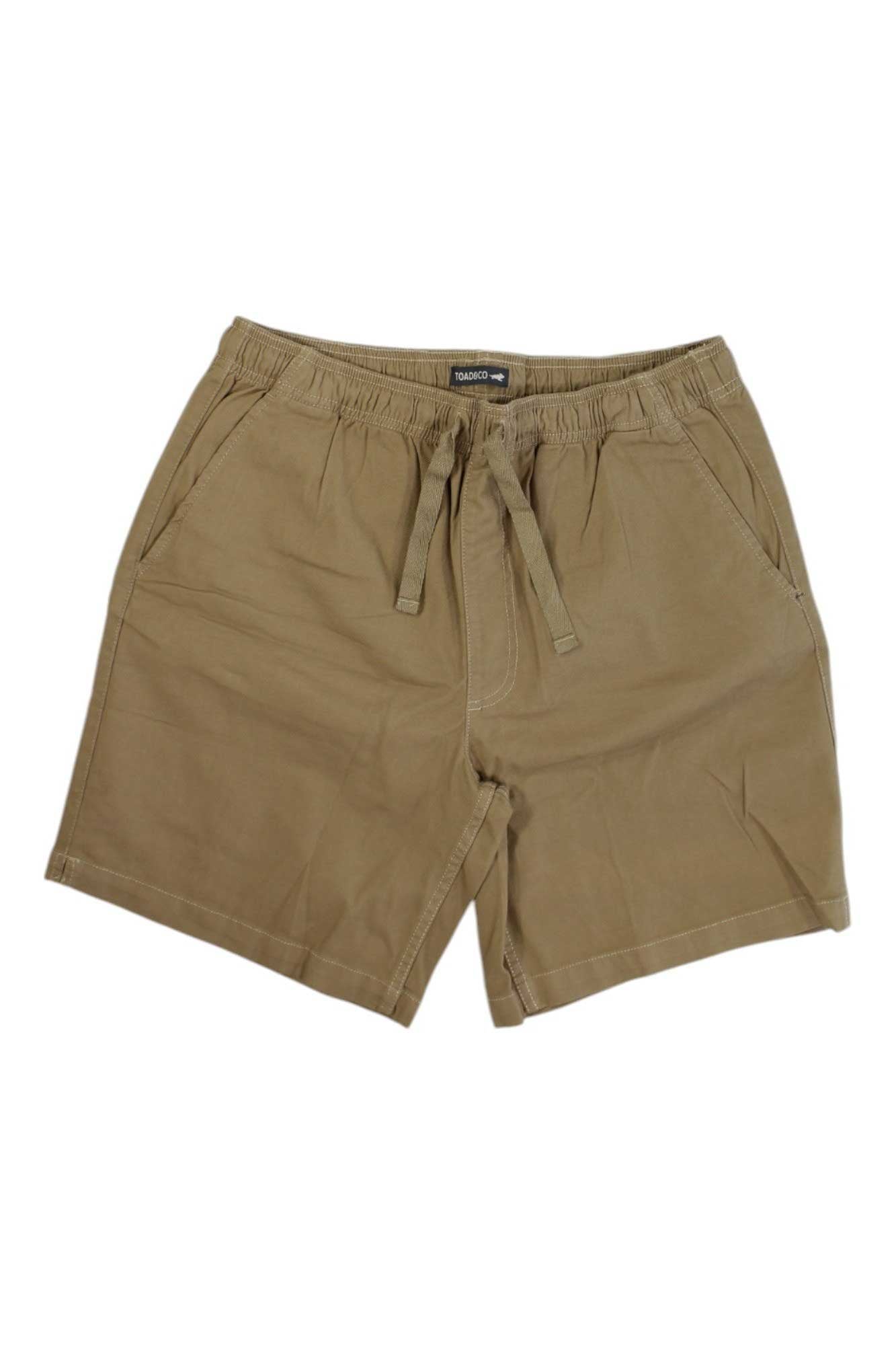 A pair of Toad & Co Men's Wanderwell Pull-On 7.5 Inch tan shorts are displayed against a white background.