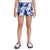 A child wearing a white T-shirt, The North Face Girls Printed Amphibious Knit Class V 3 Inch Short with moisture-wicking and quick-drying features, and light blue sandals with purple straps stands against a plain white background.