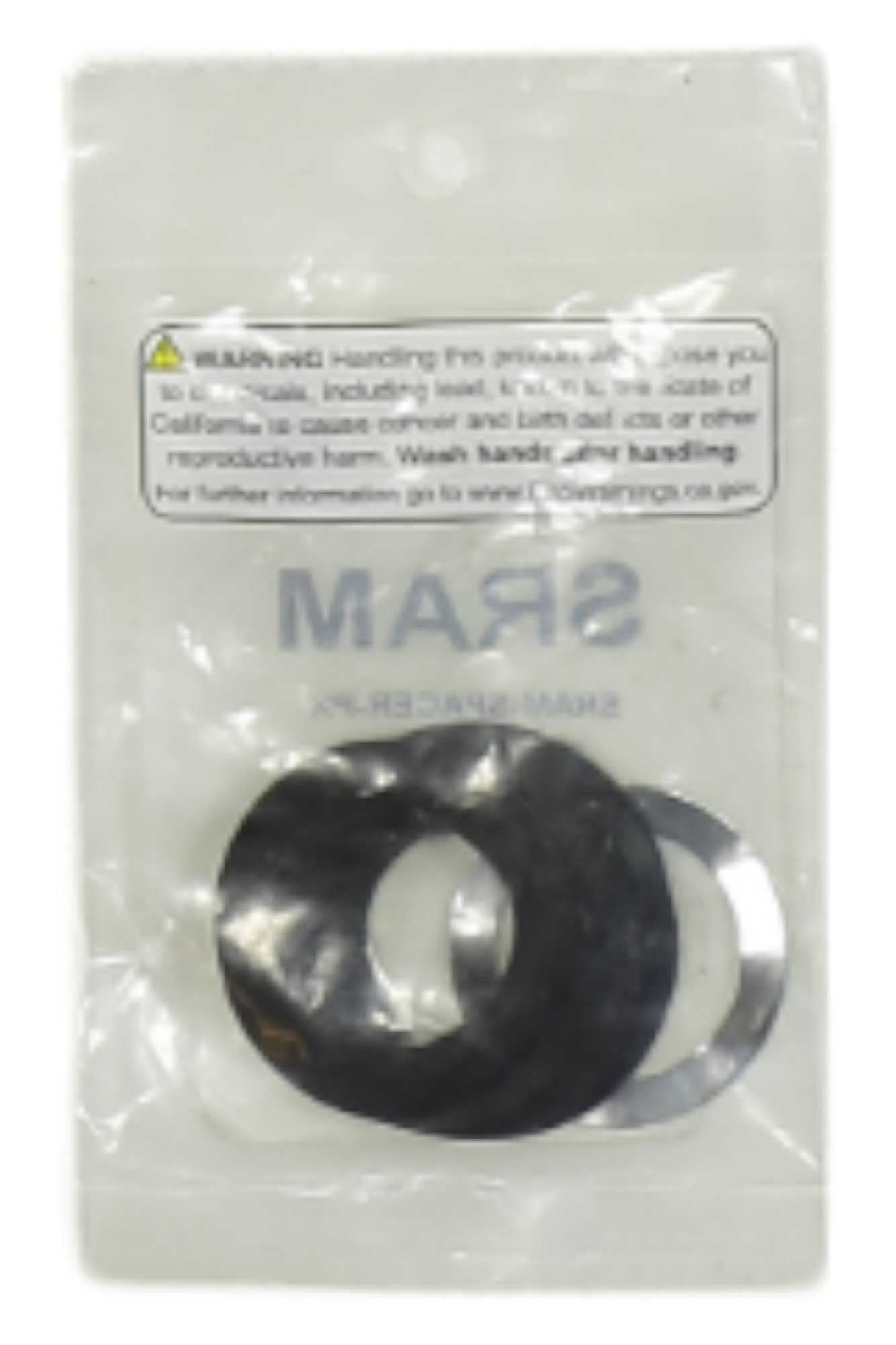 A package contains two circular metal washers, one black and one silver, with a warning label at the top. The package is labeled Wheels Manufacturing 22/24mm GXP BB Spacer Pack and is available for shops only.