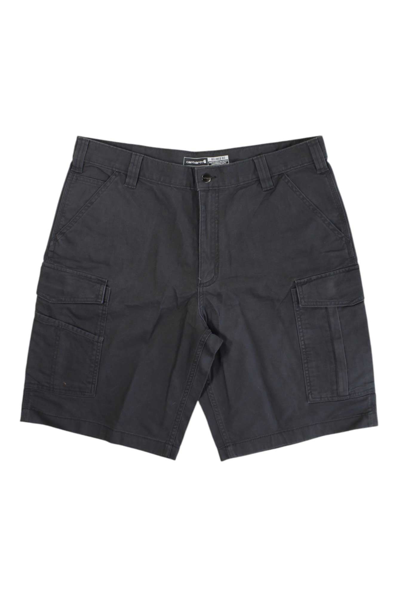 Carhartt Men's Rugged Flex Rigby Cargo 11 Inch Short in dark gray, featuring belt loops, side and back pockets, and large rugged flex flap cargo pockets on each thigh, displayed flat on a white background.