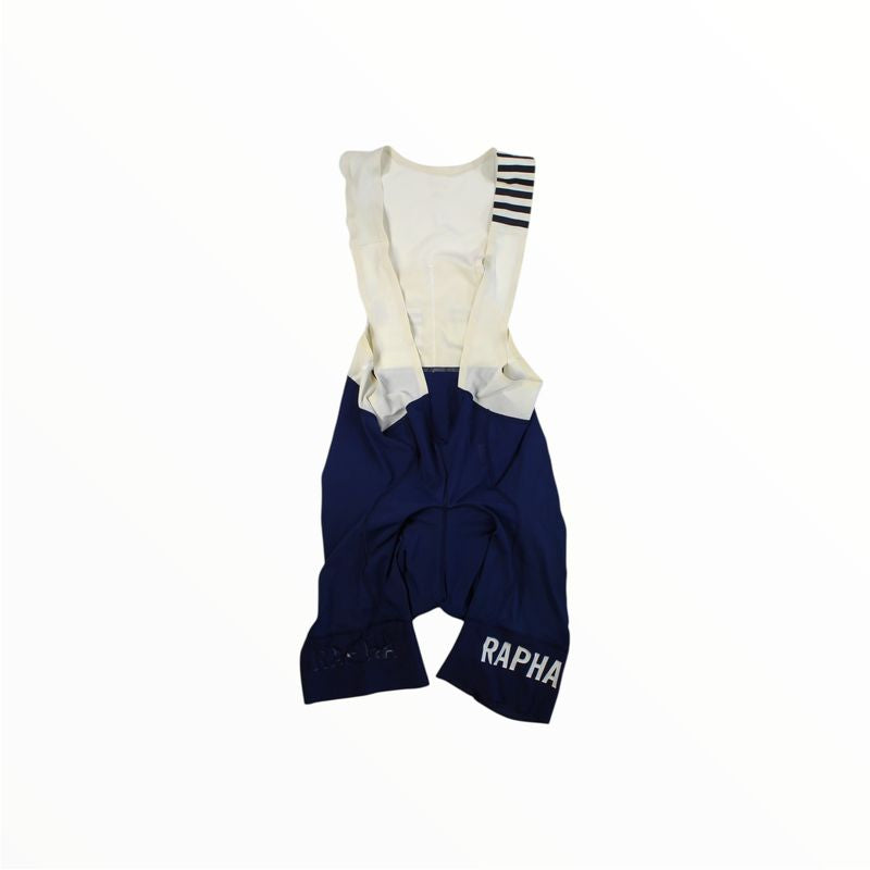 A cycling skinsuit with a white long-sleeve top featuring black stripes on one shoulder and Rapha Mens Pro Team Bib Shorts II - Regular in dark blue, race-grade chamois, displayed on a plain white background.