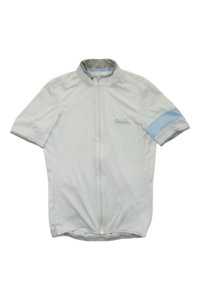 The Rapha Mens Super Lightweight Jersey is a light gray short-sleeve cycling jersey featuring a full front zipper, small Rapha logo on the left chest, and a light blue band around the left sleeve.