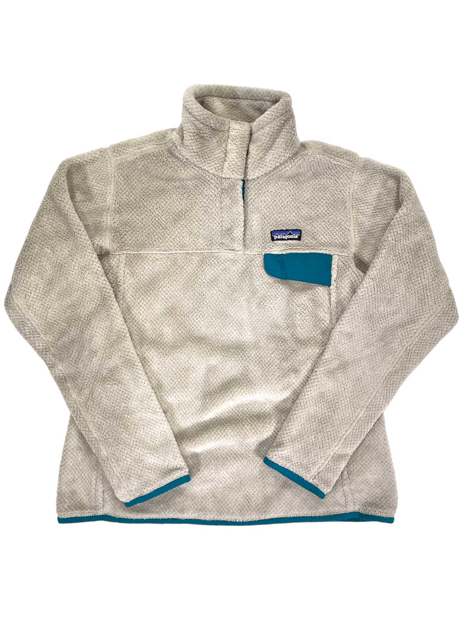 The Women's Re-Tool Snap-T Pullover is a light gray Polartec Thermal Pro fleece with a high collar, blue-trimmed chest pocket and edges, Patagonia logo on the pocket, and is Fair Trade Certified.