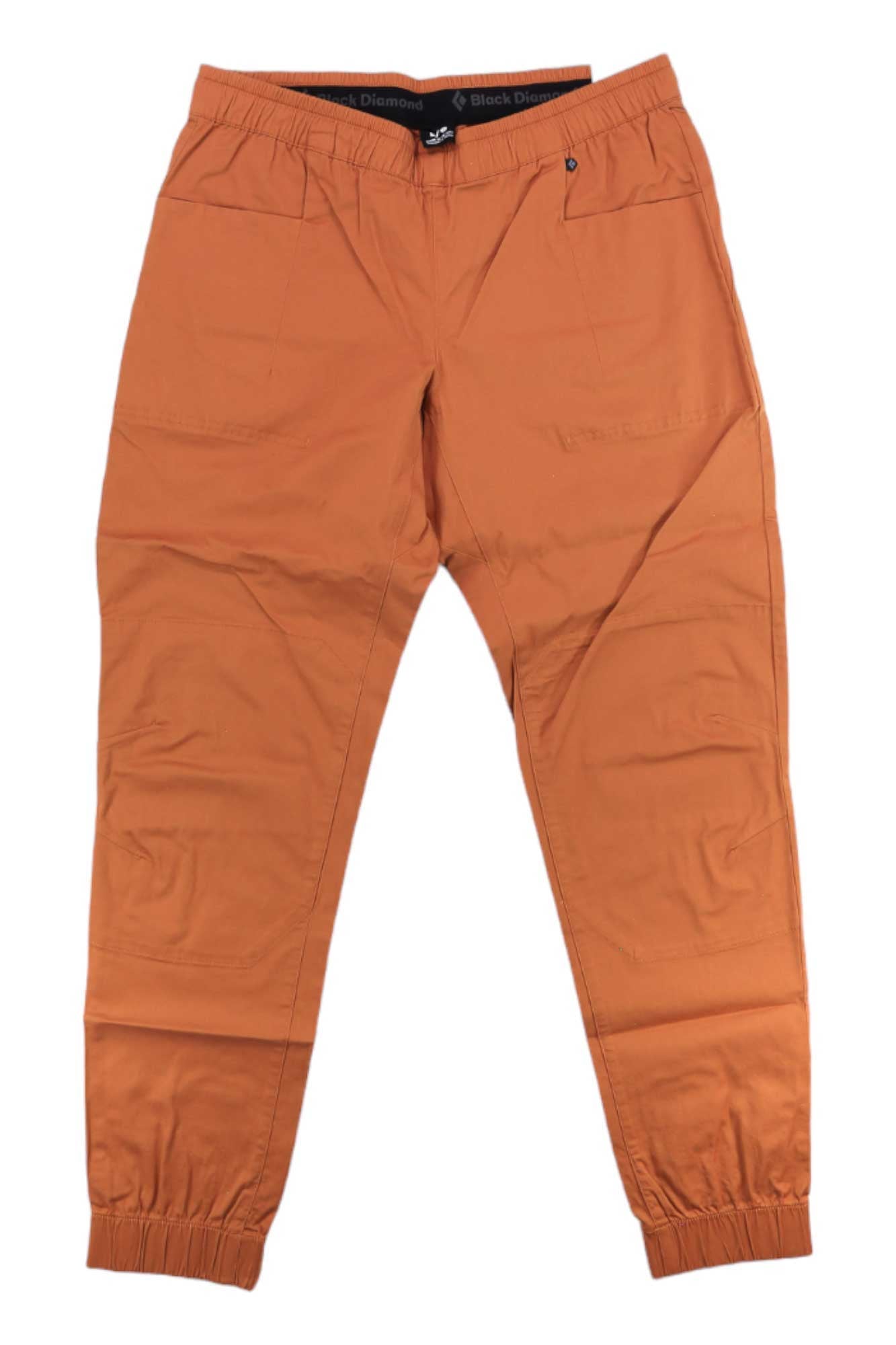 The Black Diamond Womens Notion SP Pant, orange jogger-style climbing pants made from organic cotton, features an elastic waistband, elastic ankle cuffs, and front pockets, shown laid flat on a white background.