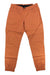 The Black Diamond Womens Notion SP Pant, orange jogger-style climbing pants made from organic cotton, features an elastic waistband, elastic ankle cuffs, and front pockets, shown laid flat on a white background.