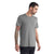A man with short dark hair and a beard wears the Icebreaker Mens Sphere II SS Tee in heather gray and black pants, standing slightly sideways to show his tattooed arm. This moisture-wicking tee is ideal for hiking, set against a plain white background.