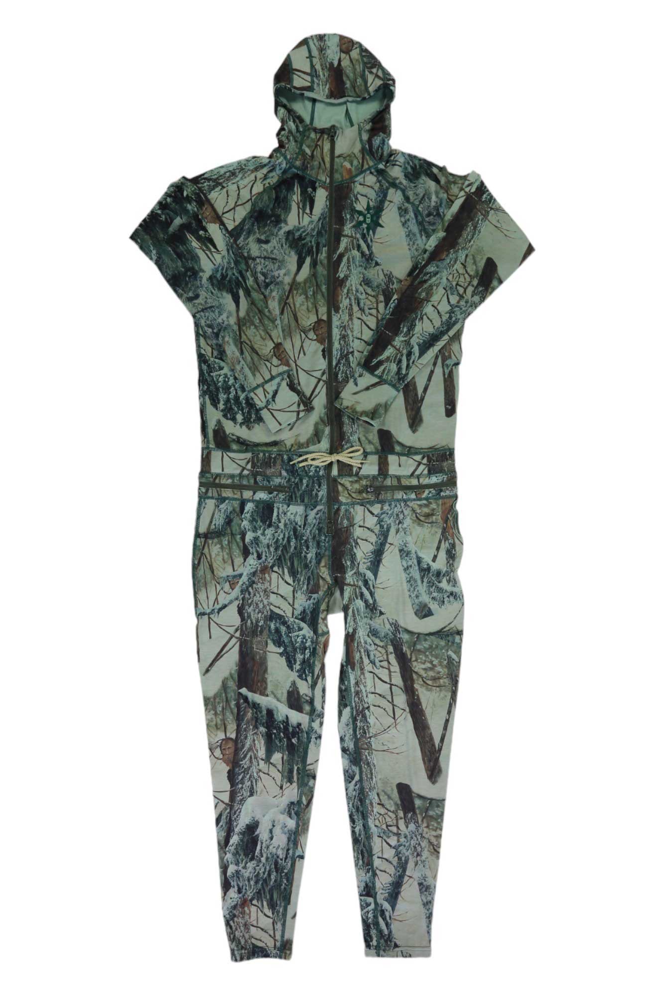 The Airblaster Mens Classic Ninja Suit is a one-piece jumpsuit with a hood, short sleeves, and zipper front, featuring green, brown, and white camouflage like a snowy forest—ideal as a men's base layer.