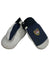A pair of Hestra Juniors Army Leather Patrol Mitt kids' mittens in navy blue and white with black cuffs. One mitten shows a patch featuring a red, white, and blue shield with "LEADER" above it. The mittens are overlapping.