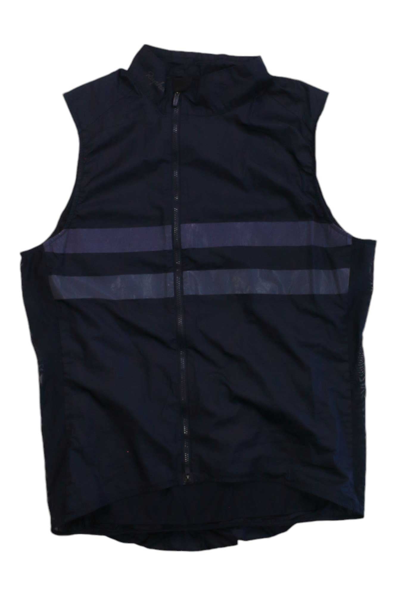 The Brevet Reflective Gilet is a sleeveless black cycling vest with a front zipper and two chest-height horizontal reflective stripes for enhanced visibility.