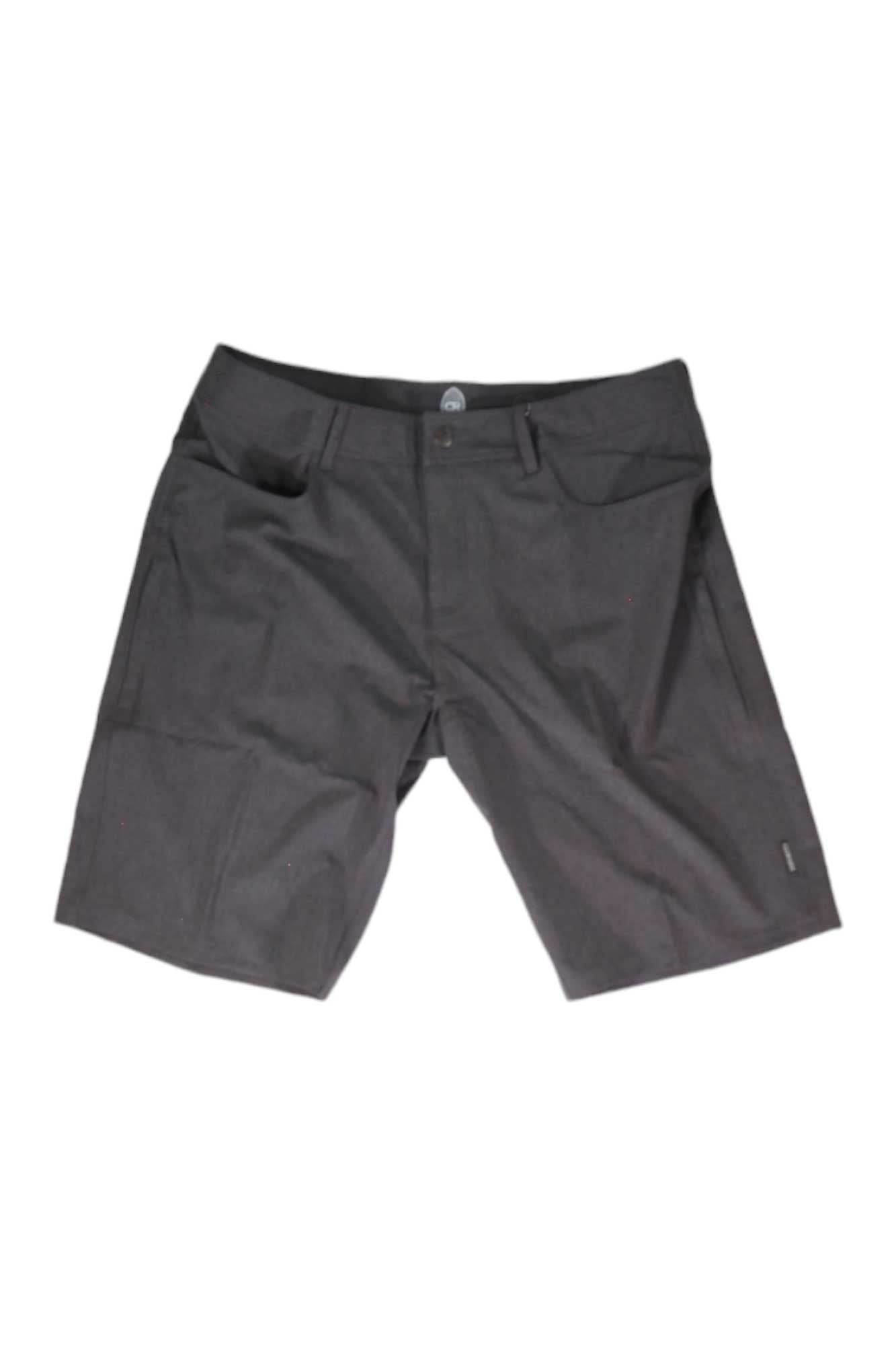 The Club Ride Mens MTN Surf 12 Inch Short in dark gray features front pockets, belt loops, and a button closure. Displayed on a white background, these water-resistant knee-length shorts are perfect for biking and provide all-day comfort.