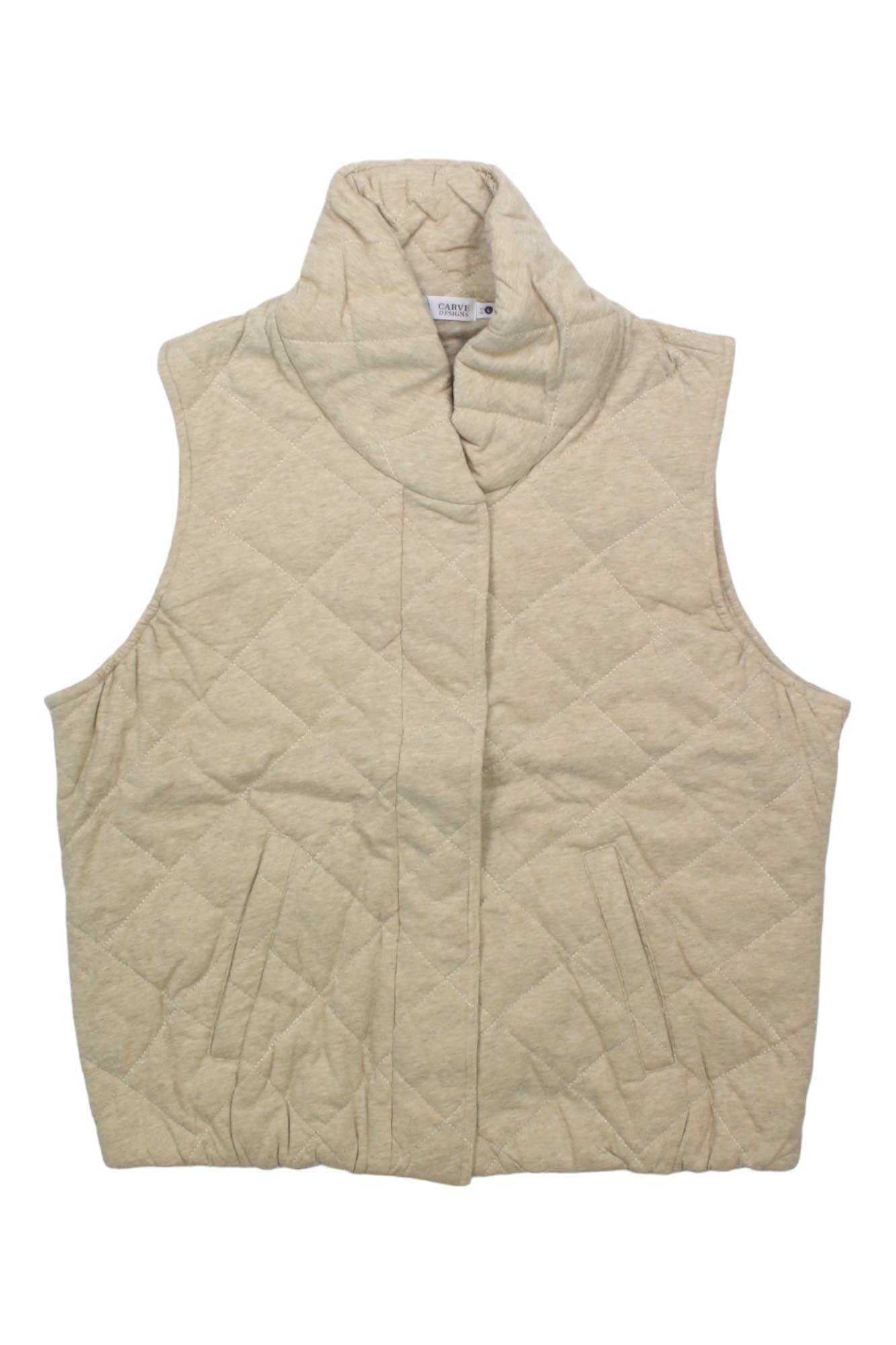 The Carve Designs Womens Betty Vest is a beige, sleeveless vest for women made from organic cotton with a high collar and two front pockets, shown laid flat on a white background.