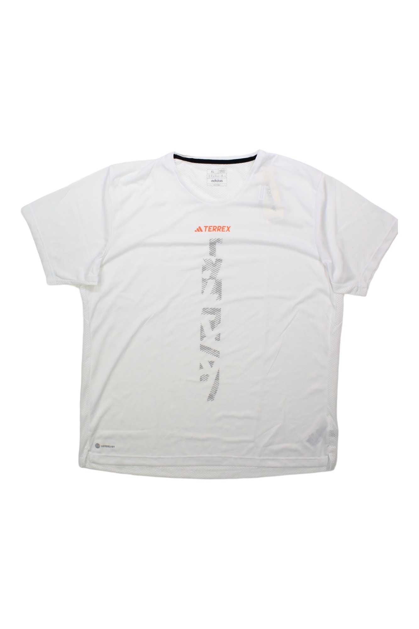 The Adidas Mens Agravic Tee is a plain white short-sleeve shirt made from recycled polyester, with a small orange Terrex logo and a large vertical gray graphic—perfect for trail running.