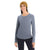 A smiling woman wears a mustard yellow knit beanie, black pants, and the Icebreaker Womens Sphere II LS Tee, made from soft merino wool, standing against a plain white background.
