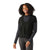 A woman with curly hair smiles in the Smartwool Womens Thermal Merino Rib Top—black, with ribbed sleeves and a drawstring waist—paired with dark jeans against a white background. Ideal for layering on snowsports adventures.