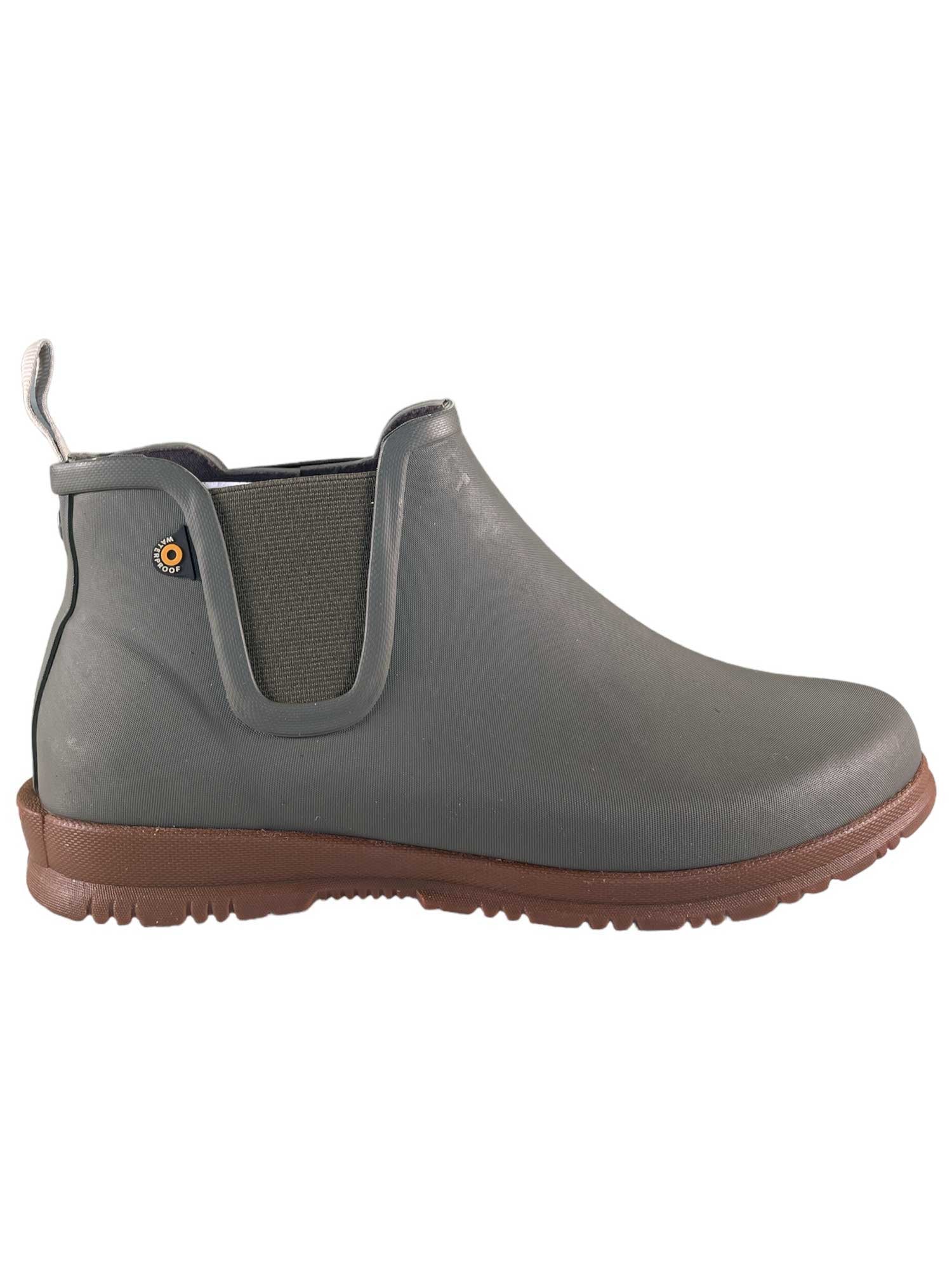 The Sweetpea Rain Boots are gray, waterproof ankle boots with a brown sole, elastic side panel, back pull tab, and a small circular logo near the ankle—ideal women's boots for rainy days.