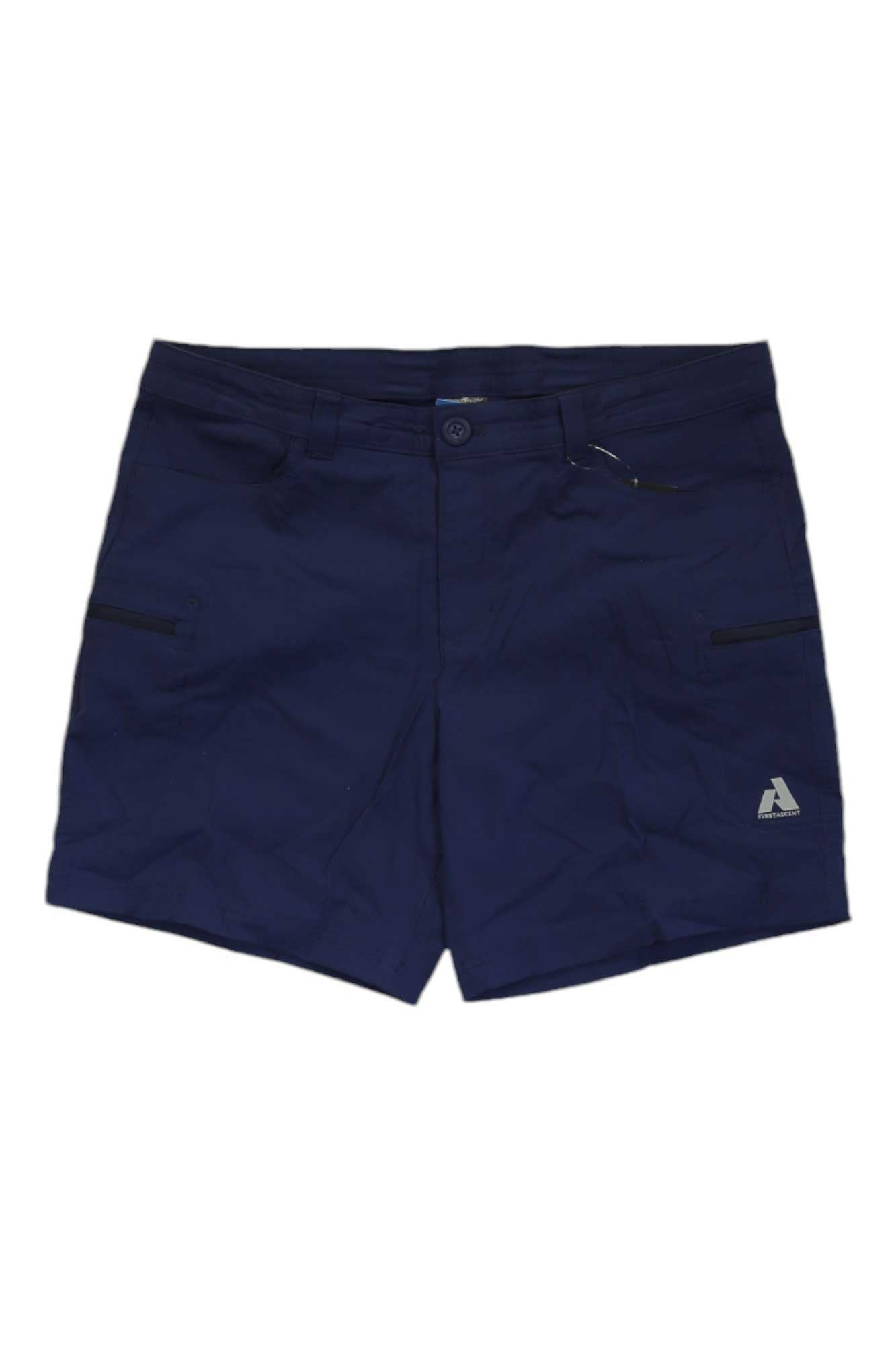 The Eddie Bauer First Ascent Women's Guide Pro Short features navy blue, water-resistant fabric, front button and zipper, UPF 50+ sun protection, side zip pockets, belt loops, and a small triangular logo on the bottom right leg.