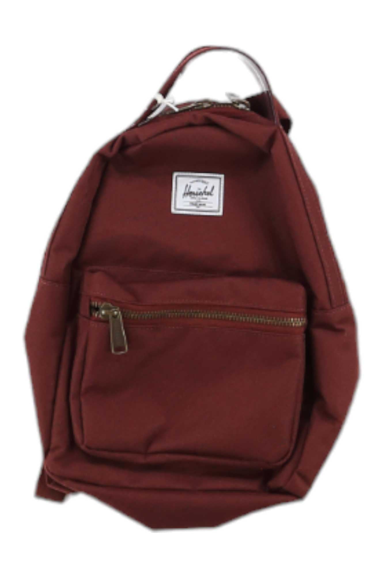The Herschel Supply Co Nova Mini Backpack is maroon with a front zippered pocket, white rectangular patch label, brown zipper pulls, metal zippers, top handle, and adjustable shoulder straps for a simple, functional design.