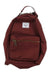 The Herschel Supply Co Nova Mini Backpack is maroon with a front zippered pocket, white rectangular patch label, brown zipper pulls, metal zippers, top handle, and adjustable shoulder straps for a simple, functional design.