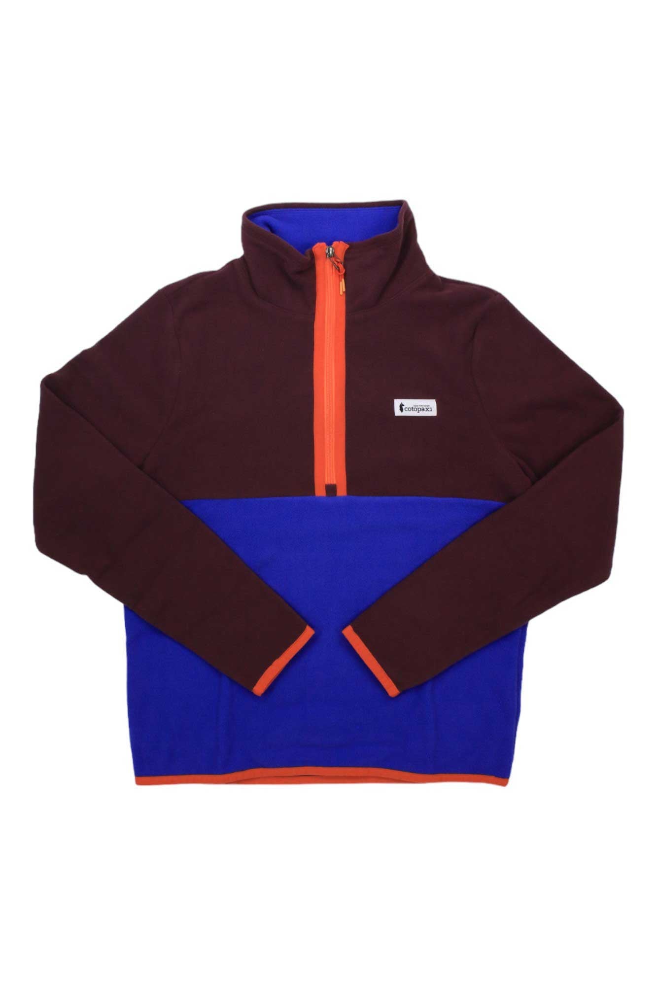 The Cotopaxi Womens Amado 1/4 Zip Fleece Pullover features a maroon top, bright blue lower half, orange trim and half-zip, a small chest logo patch, and is made with recycled fleece for warmth and sustainability.