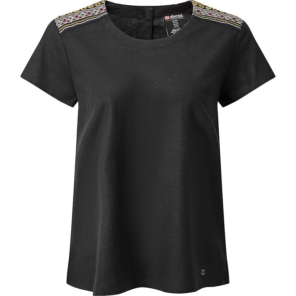 The Sherpa Women's Kiran Embroidery Top in black is a short-sleeved, eco-friendly top with colorful Nepalese patterns on the shoulders, a round neckline, and a relaxed fit, displayed on a white background.