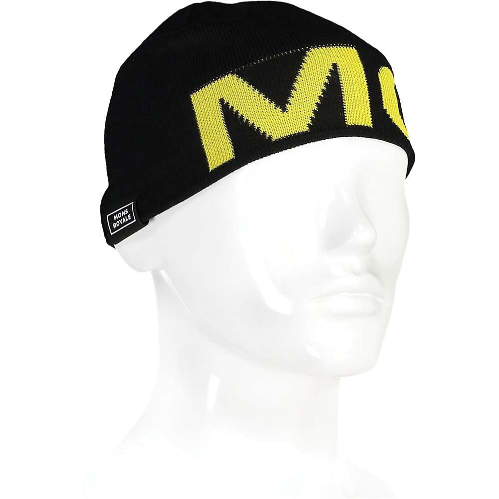 The Mons Royale Arcadia Merino Wool Beanie is crafted from moisture-wicking merino wool and features a bold yellow M logo along with the signature MONS ROYALE tag.