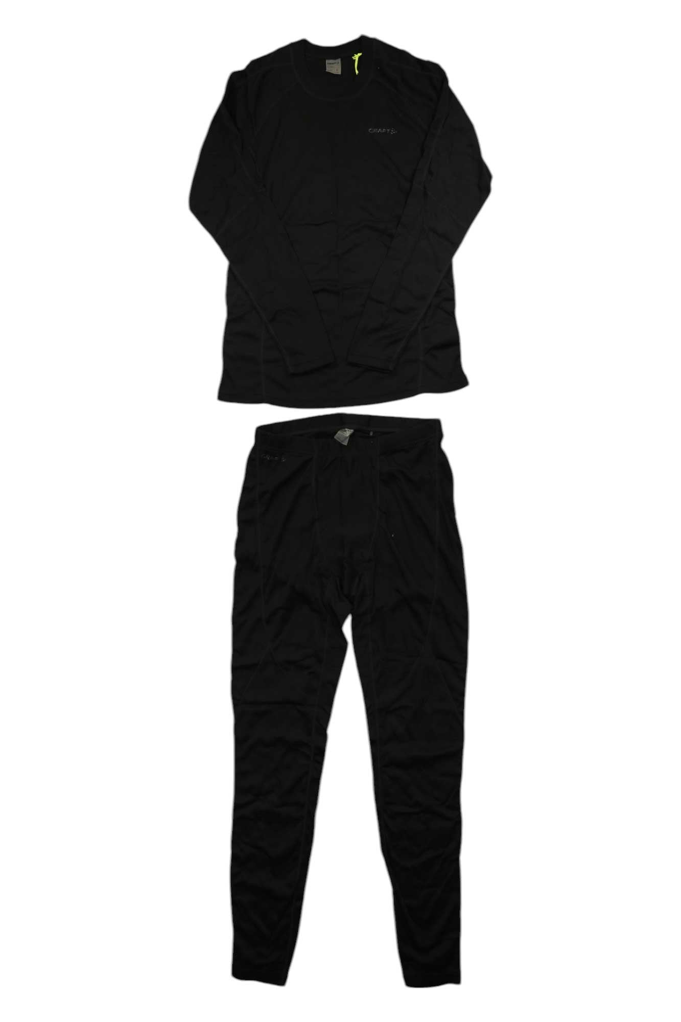 The Craft Sportswear Men's Core Warm Baselayer Set in black includes a moisture-wicking long-sleeve shirt and pants, shown laid flat on white—ideal for skiing or cold-weather activities.