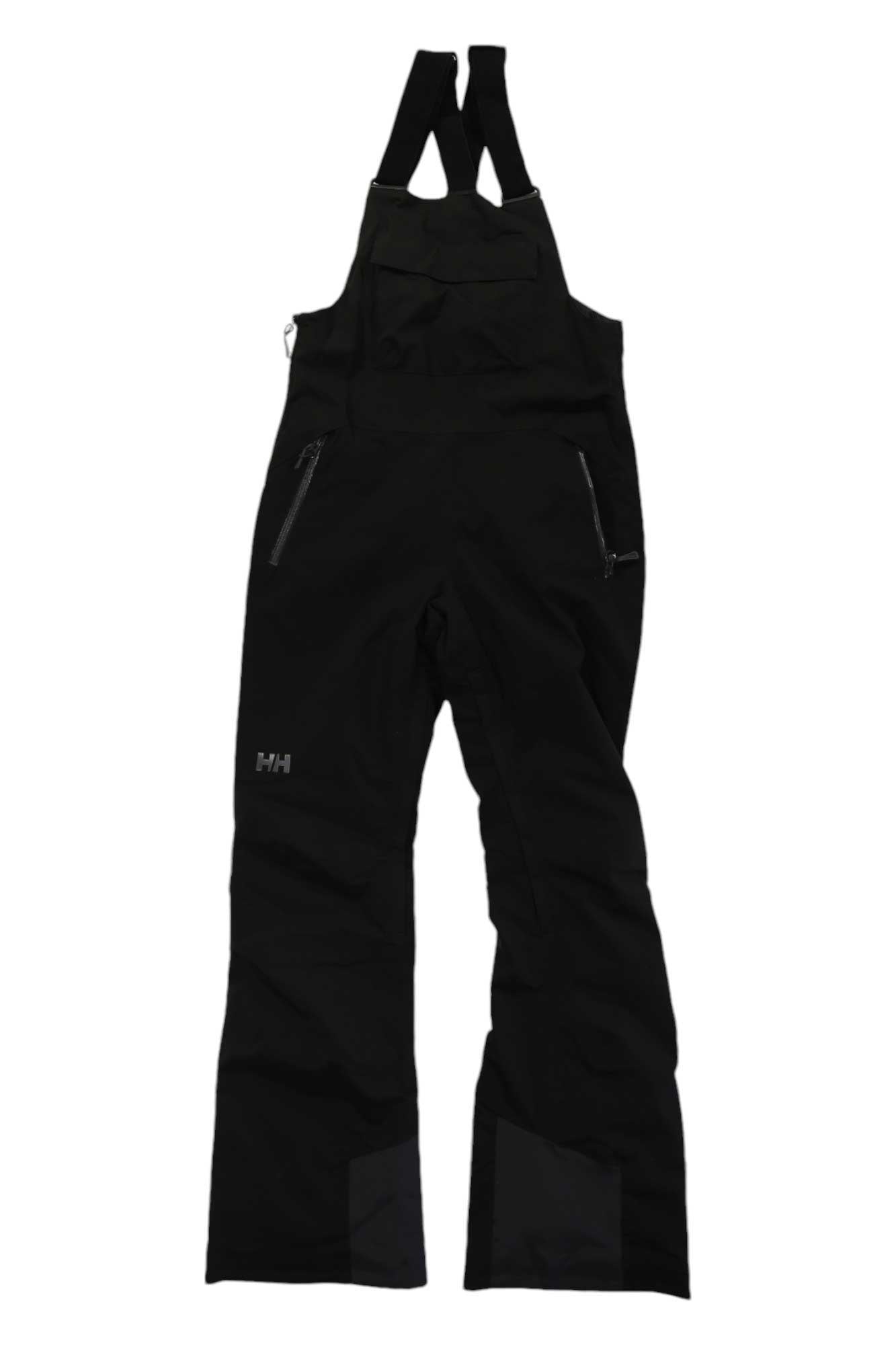 The Helly Hansen Womens Legendary Insulated Bib Pant features adjustable shoulder straps, multiple zippered pockets, and reinforced ankle fabric. These black snow pants are insulated and shown laid flat on a white background.