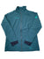 A teal Womens Togiak Soft Shell Jacket with long sleeves, black wrist cuffs, and chest and shoulder logos. This lightweight jacket features Polartec Alpha Direct, shown laid flat on a white background.