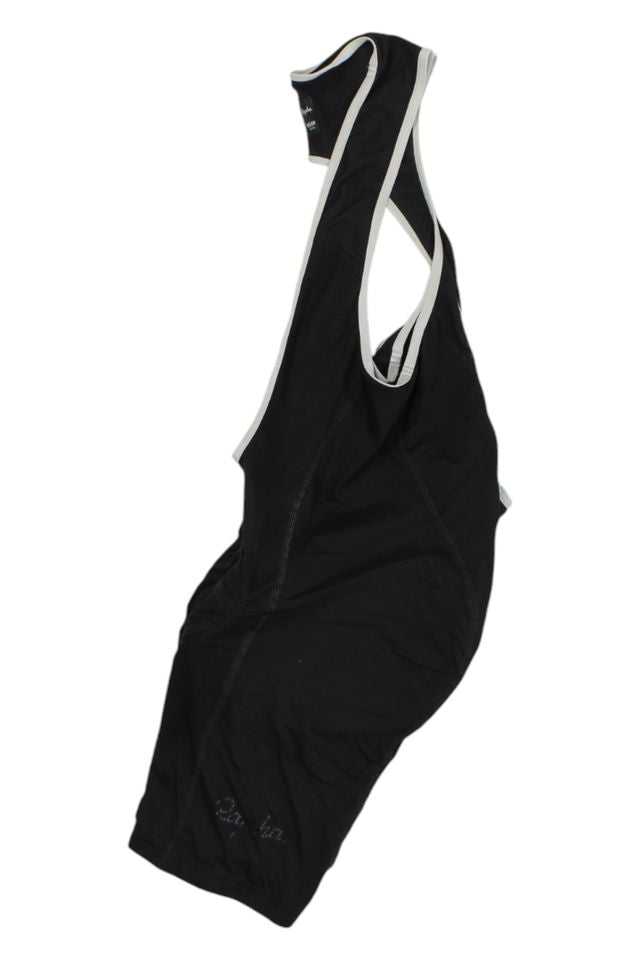A pair of Mens Bib Shorts in black with white-trimmed shoulder straps lies flat on a white background—an essential piece of men's cycling apparel.