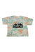 The KAVU Womens Malin Top is a pastel green and orange short-sleeve tie-dye travel shirt made from organic cotton, featuring a large black KAVU logo and “Klear Above Visibility Unlimited” text on the front.