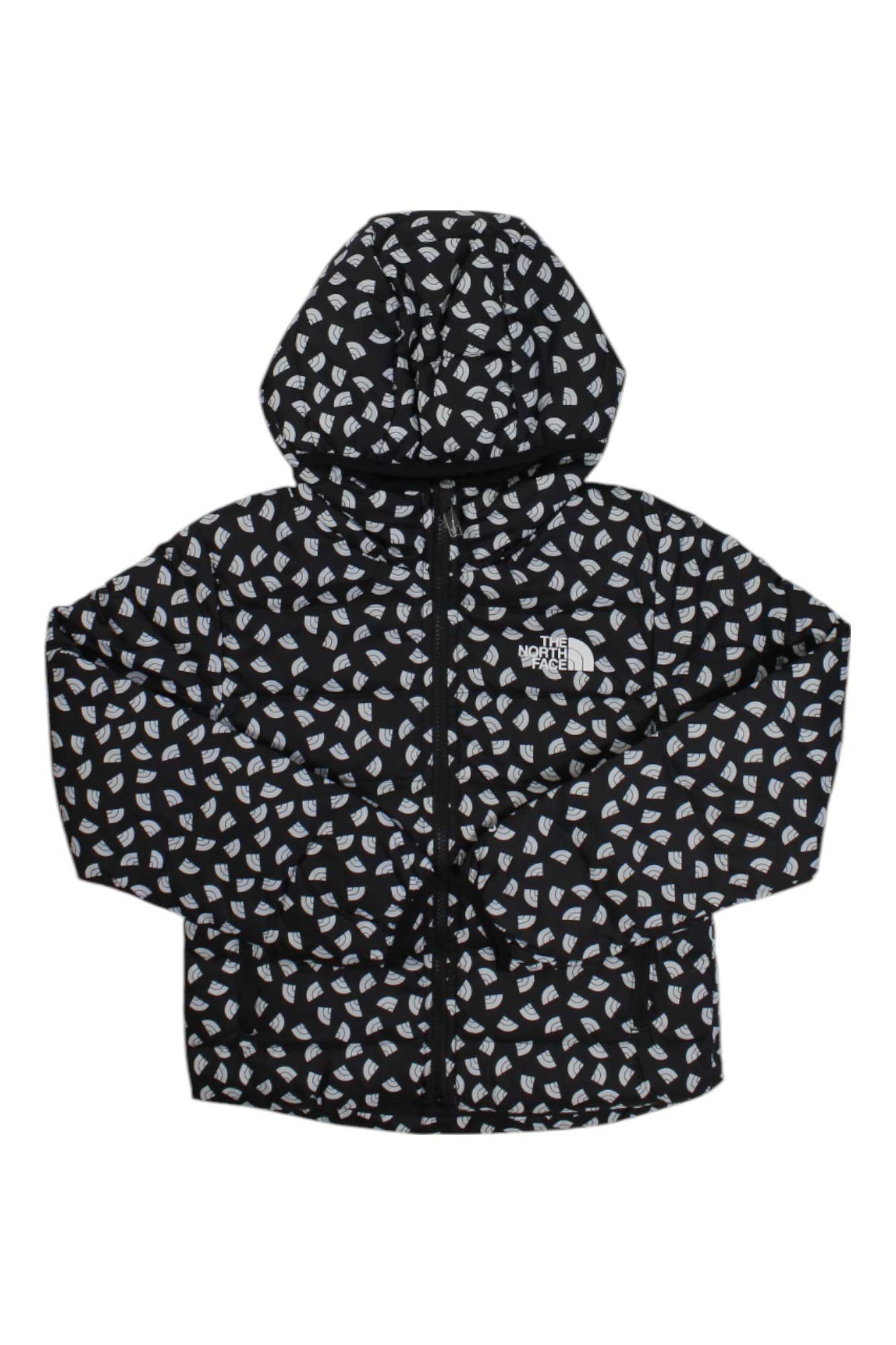 The North Face Girls Reversible North Down Hooded Jacket is a black, water-resistant puffer with a white and gray geometric pattern, front zipper, long sleeves, hood, and logo on the left chest for extra warmth.