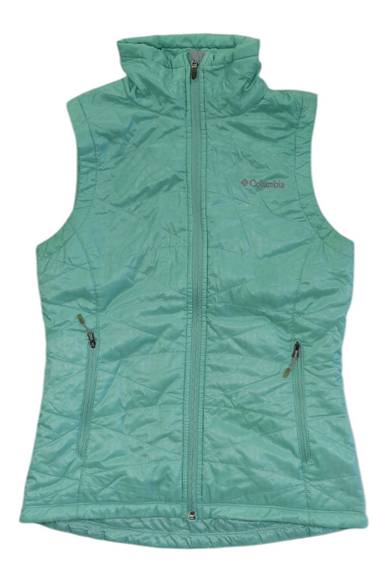 The Columbia Women's Mighty Lite III Vest in light teal features synthetic insulation, a zip-up front, two zippered pockets, and a high collar. The sleeveless vest is displayed flat on a white background.