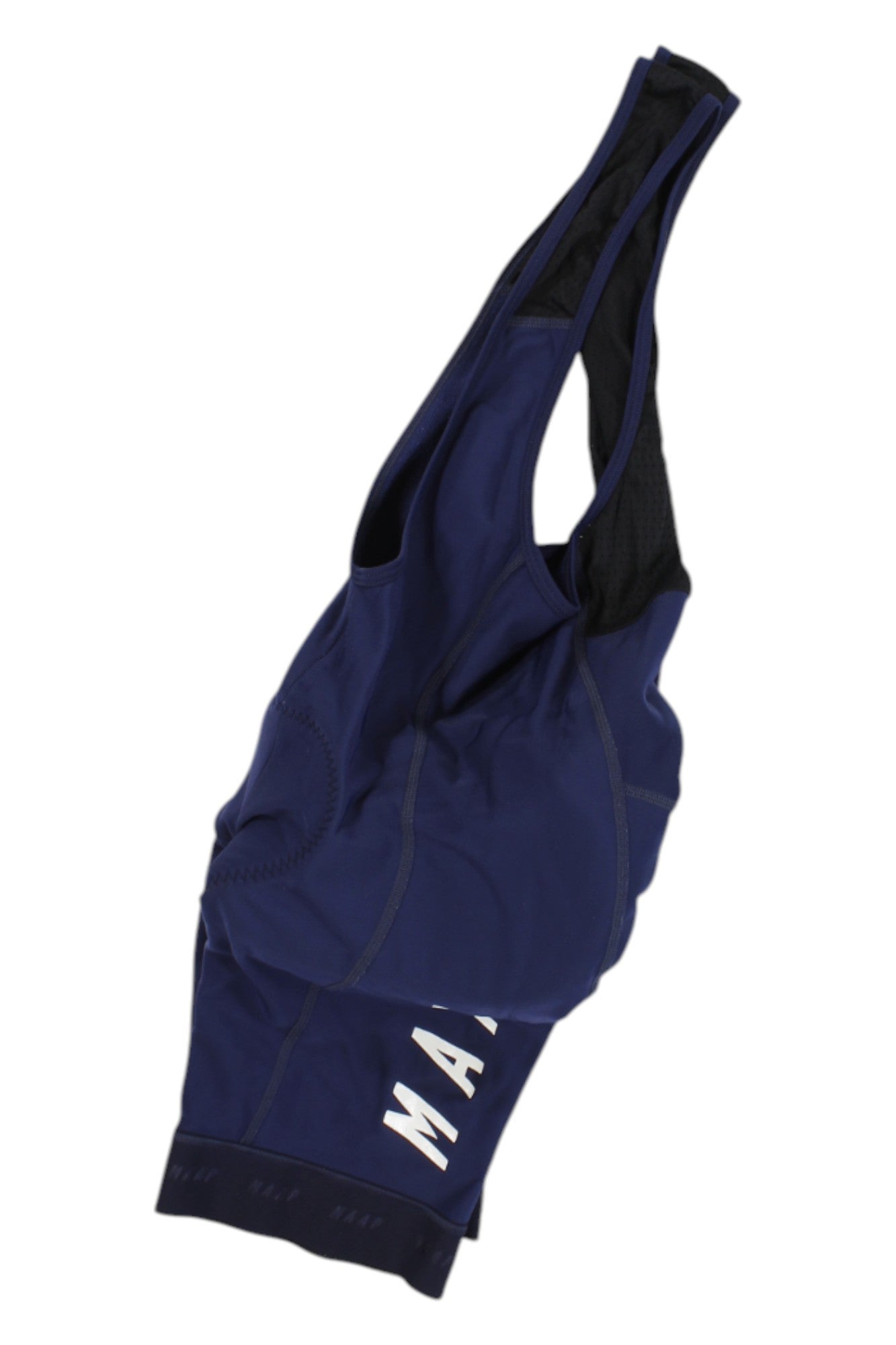 A pair of Maap Pro Bib cycling shorts in navy blue with black mesh straps, chamois padding, and "MAAP" in white letters on the left thigh, shown laid flat and partially folded.