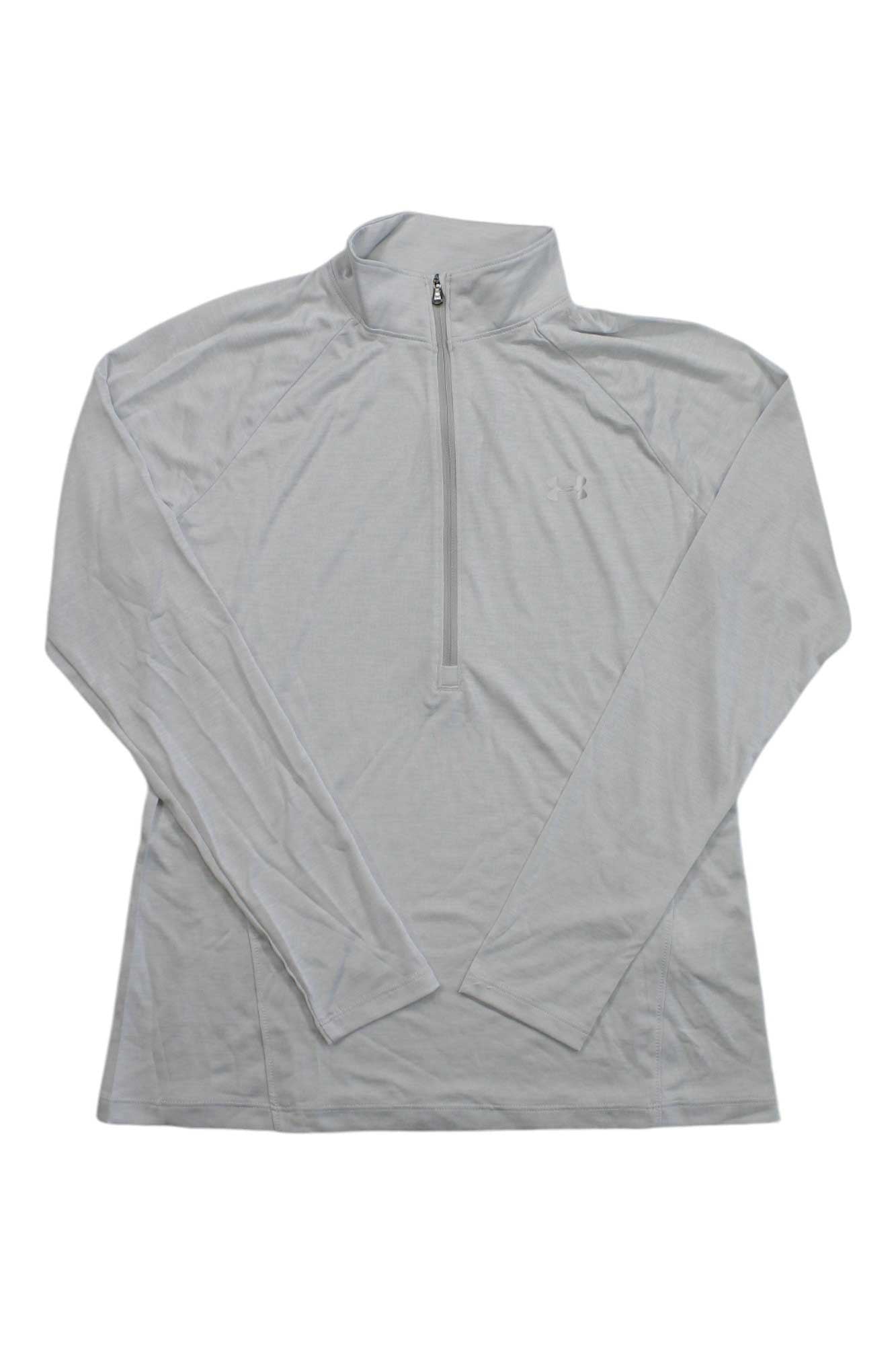 The Under Armour Womens UA Tech Twist 1/2 Zip Top is a light gray, long-sleeve fitness pullover with a quarter-zip front and mock neck, shown laid flat on a white background. Moisture-wicking design keeps you comfortable during workouts.