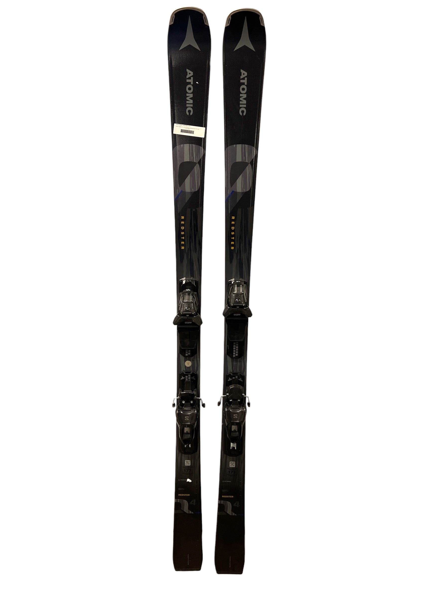A pair of Atomic Redster Q4 skis with M10 GW bindings, black, stand upright side by side against a white background, designed for superior carving performance.