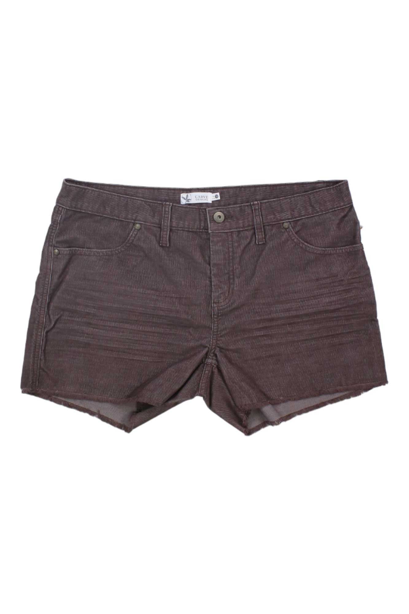 The Carve Designs Women's Oahu 4 Inch Short is a slim-fit brown denim short for women featuring a raw hem, front button and zipper closure, two front pockets, visible stitching, and a waistband label.