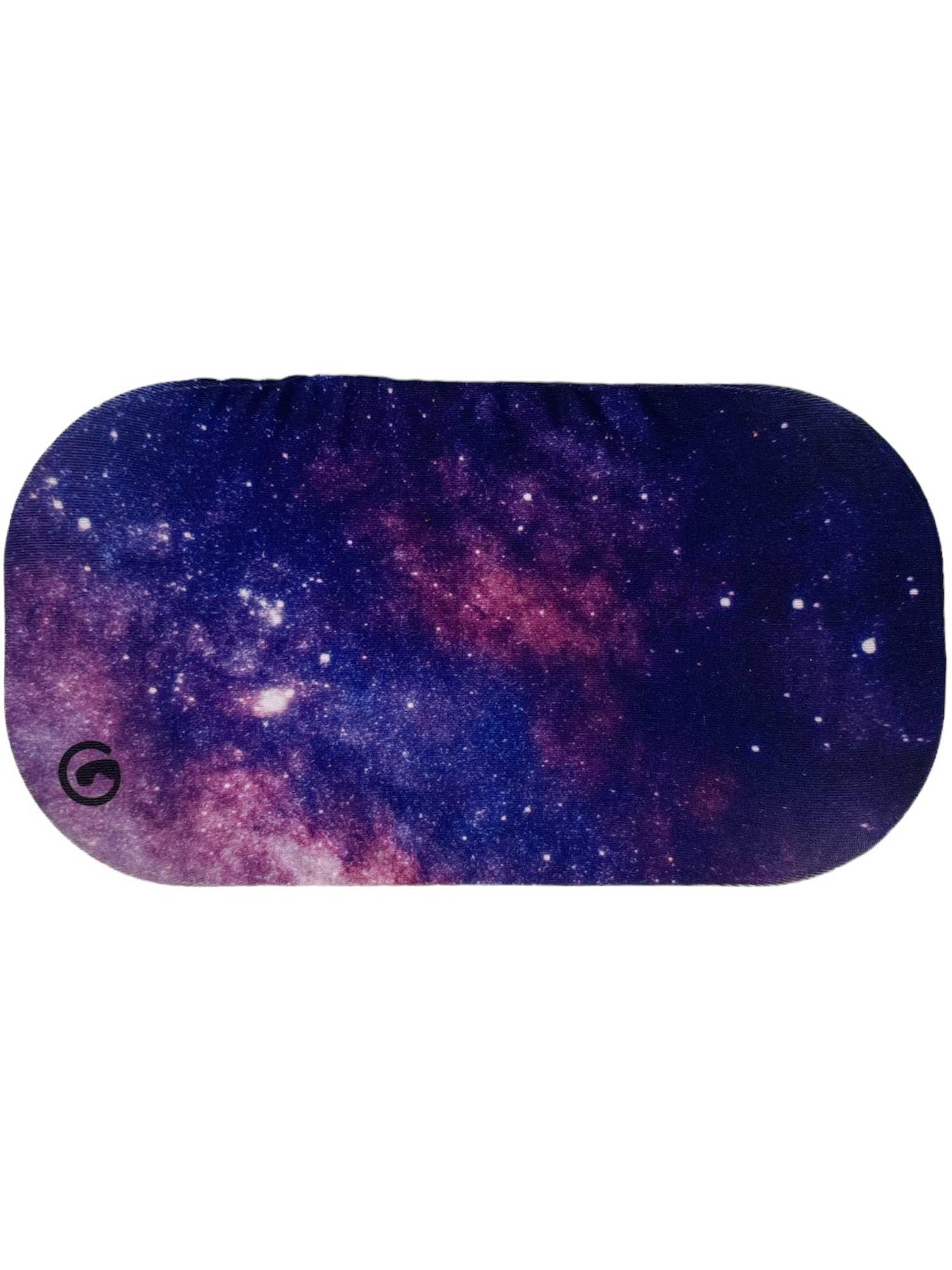 The GoggleSoc Protective Goggle Cover is a soft, oval sleep mask featuring a vibrant starry galaxy design in purple, pink, and blue tones. It’s eco-friendly and protective, with a small logo on the lower left corner.