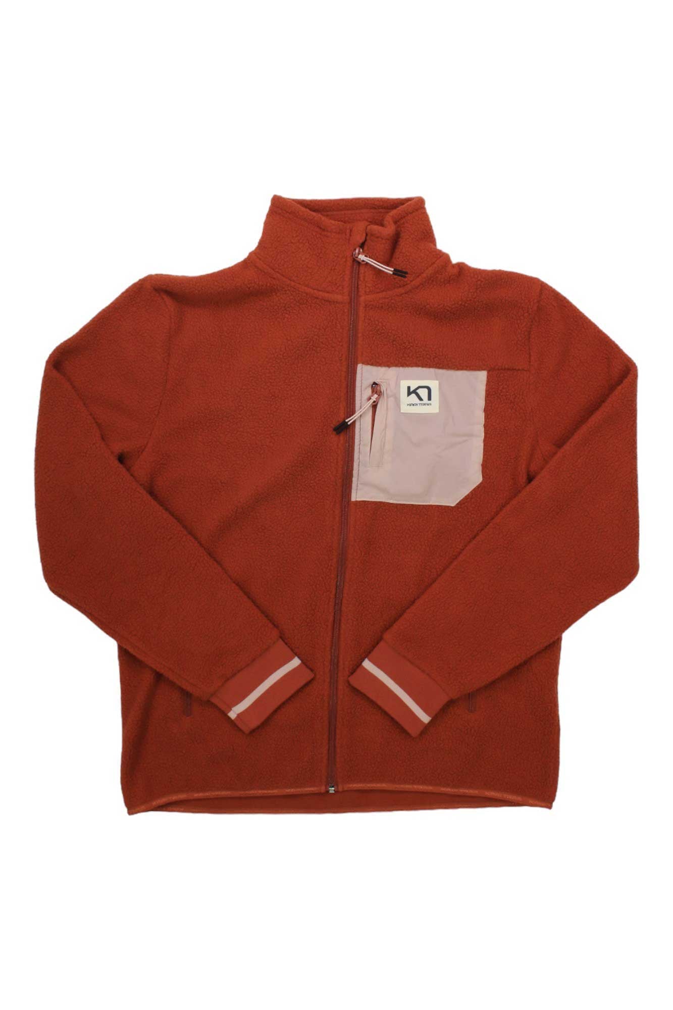 The Rothe Fleece Jacket is a rust-colored women’s pullover with a full zip, pink chest pocket, high collar, long sleeves, logo patch, and is made from bluesign approved materials—ideal for snowsports.
