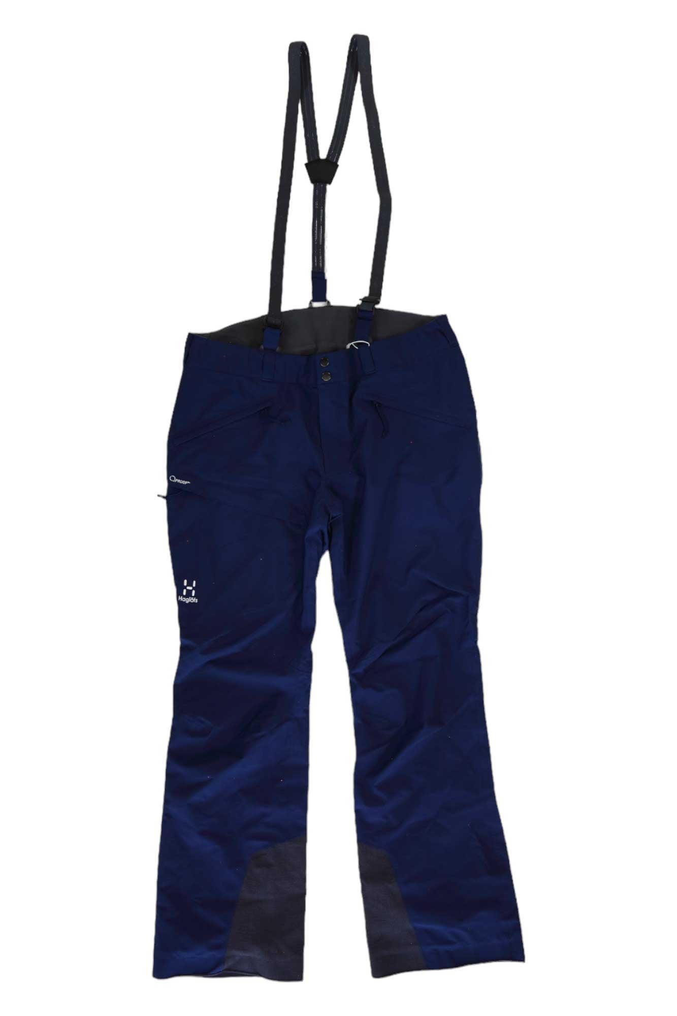 The Haglofs Mens Lumi Form Pant is a dark blue ski pant with adjustable black suspenders, a front zipper, side pockets, reinforced black ankle patches, and a white logo on the left thigh. Made from recycled polyester for lasting durability.