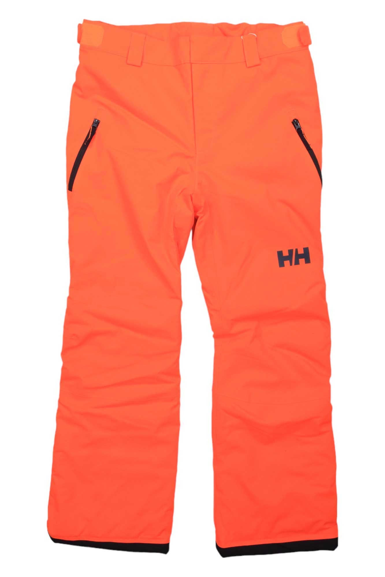 The Helly Hansen Juniors Legendary Pant is bright orange with two zippered side pockets, belt loops, and an HH logo on the left thigh. These waterproof ski pants are displayed flat on a white background.
