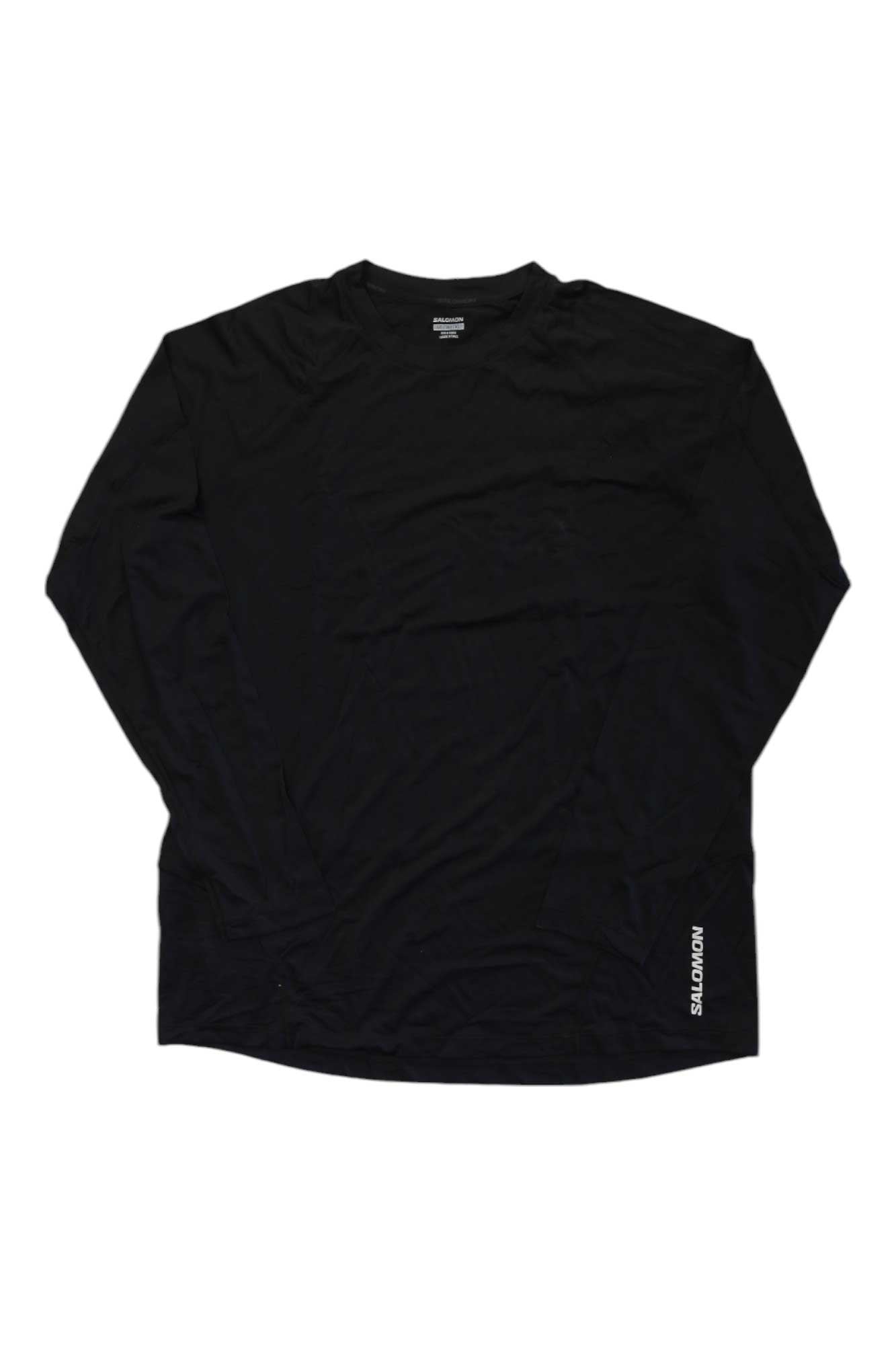 The Salomon Mens Cross Run LS Tee is a black, long sleeve crew neck shirt with "MOMENTS" printed in white near the bottom hem on one side, shown laid flat on a white background.