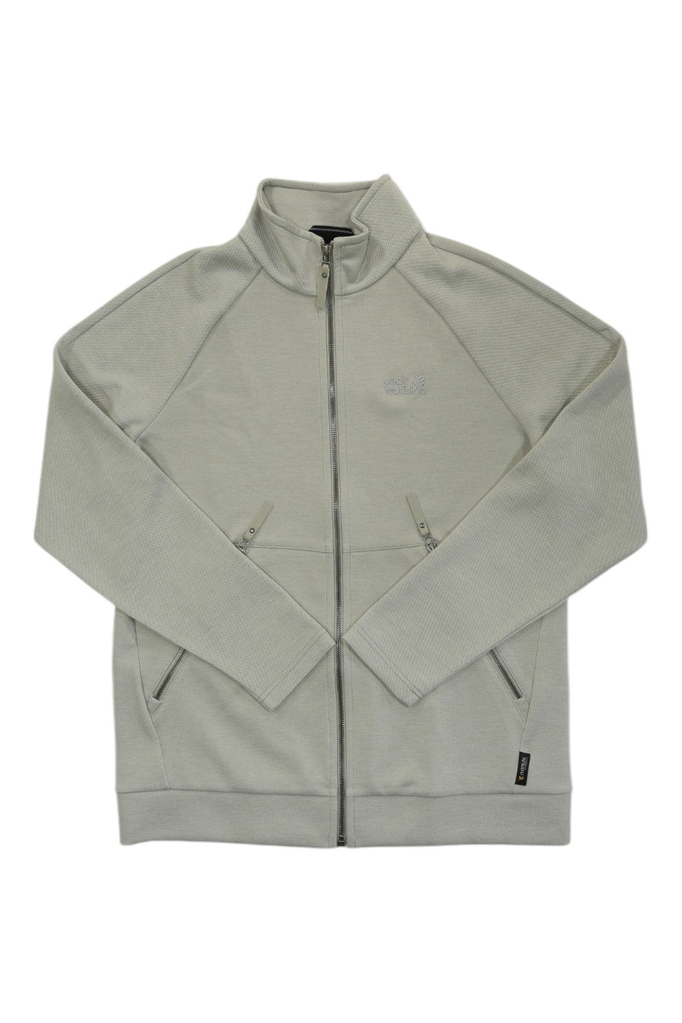 The Jack Wolfskin Mens Bilbao Jacket is a light grey outdoor jacket with textured fabric, two zippered front pockets, and a logo on the left chest.