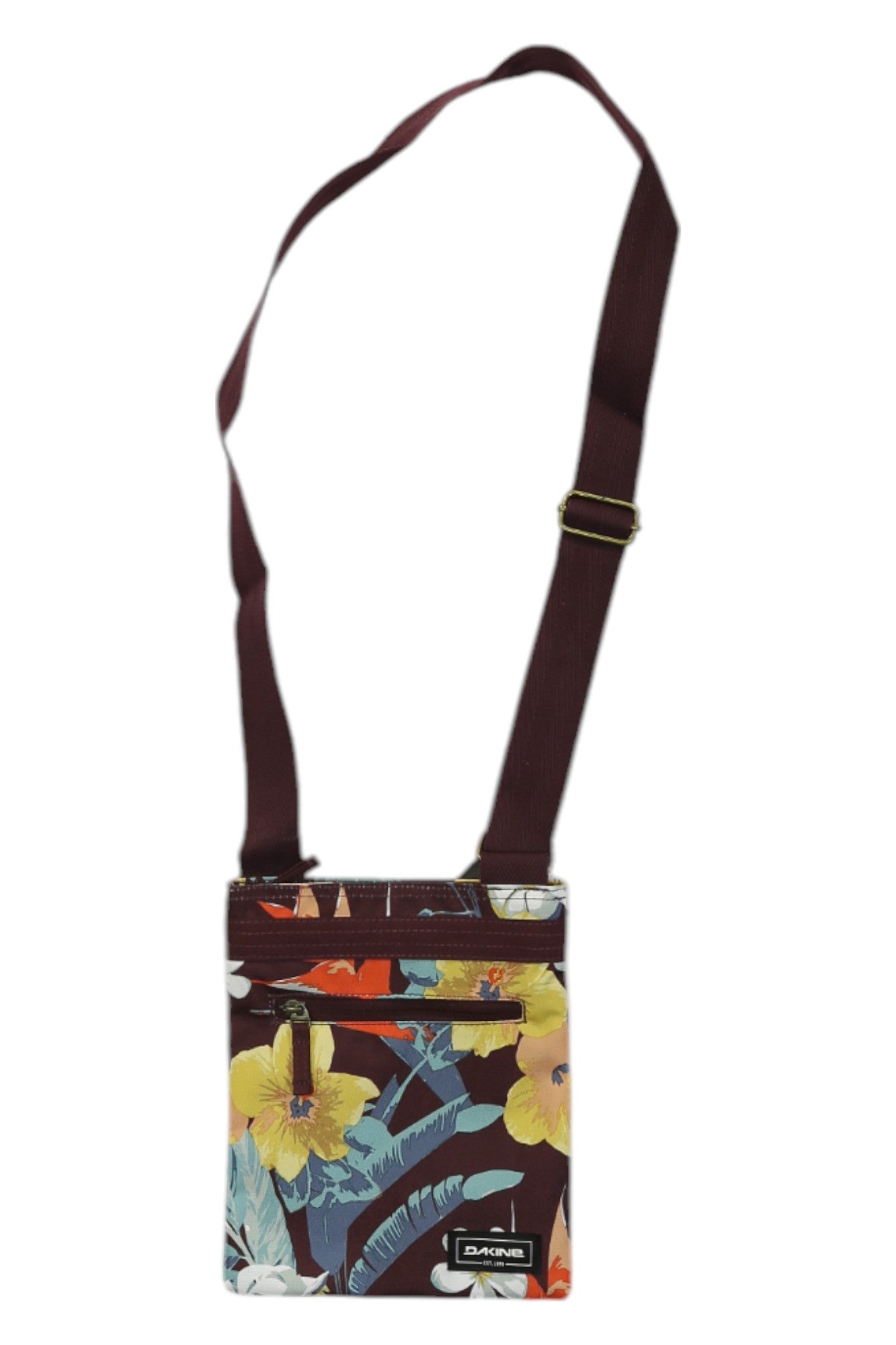 The Jive Crossbody Bag is a small Dakine bag with a maroon adjustable strap and a red, yellow, blue, and green floral pattern. It features a zippered front pocket and a rectangular Dakine logo patch at the bottom.