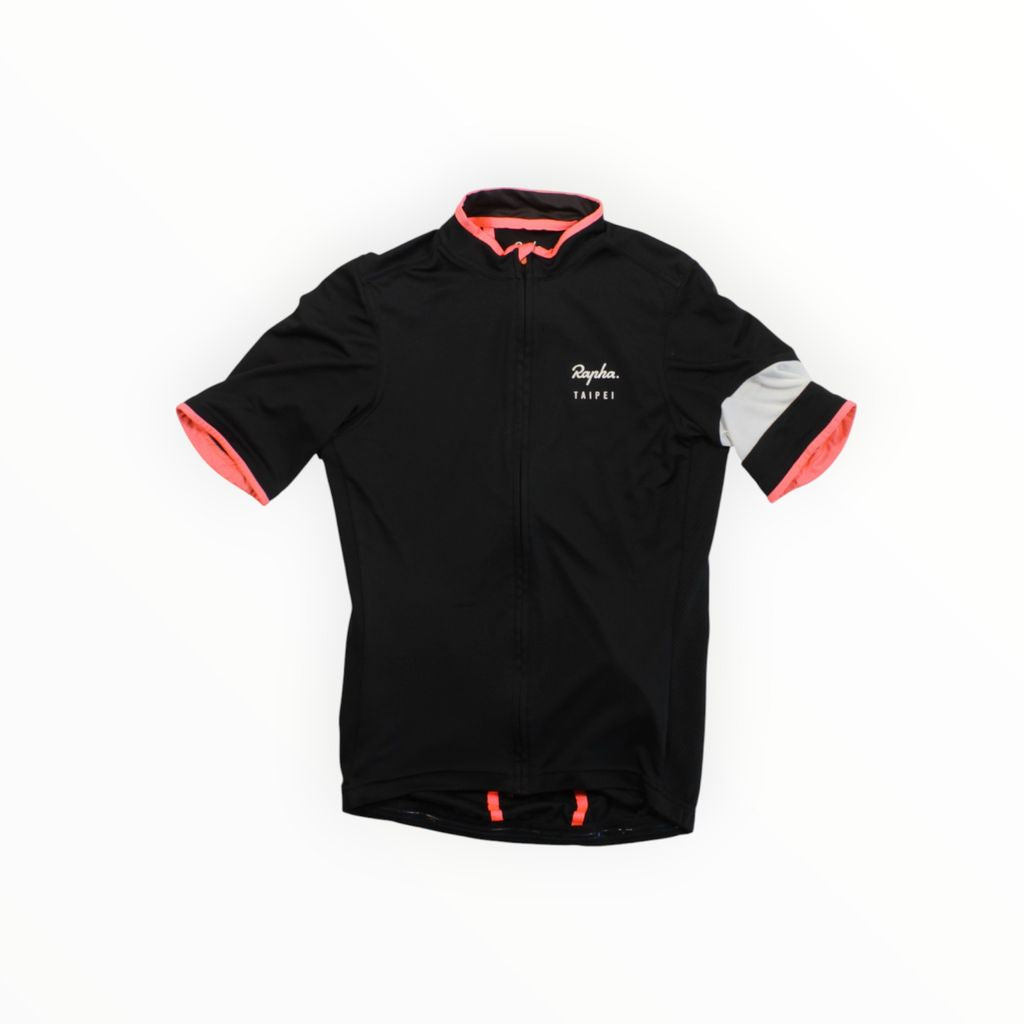 The Rapha Mens Super Lightweight Jersey is a black short-sleeve cycling jersey with pink accents on the collar and cuffs, a gray band on the left sleeve, and white "Rapha TAIPEI" text on the chest.