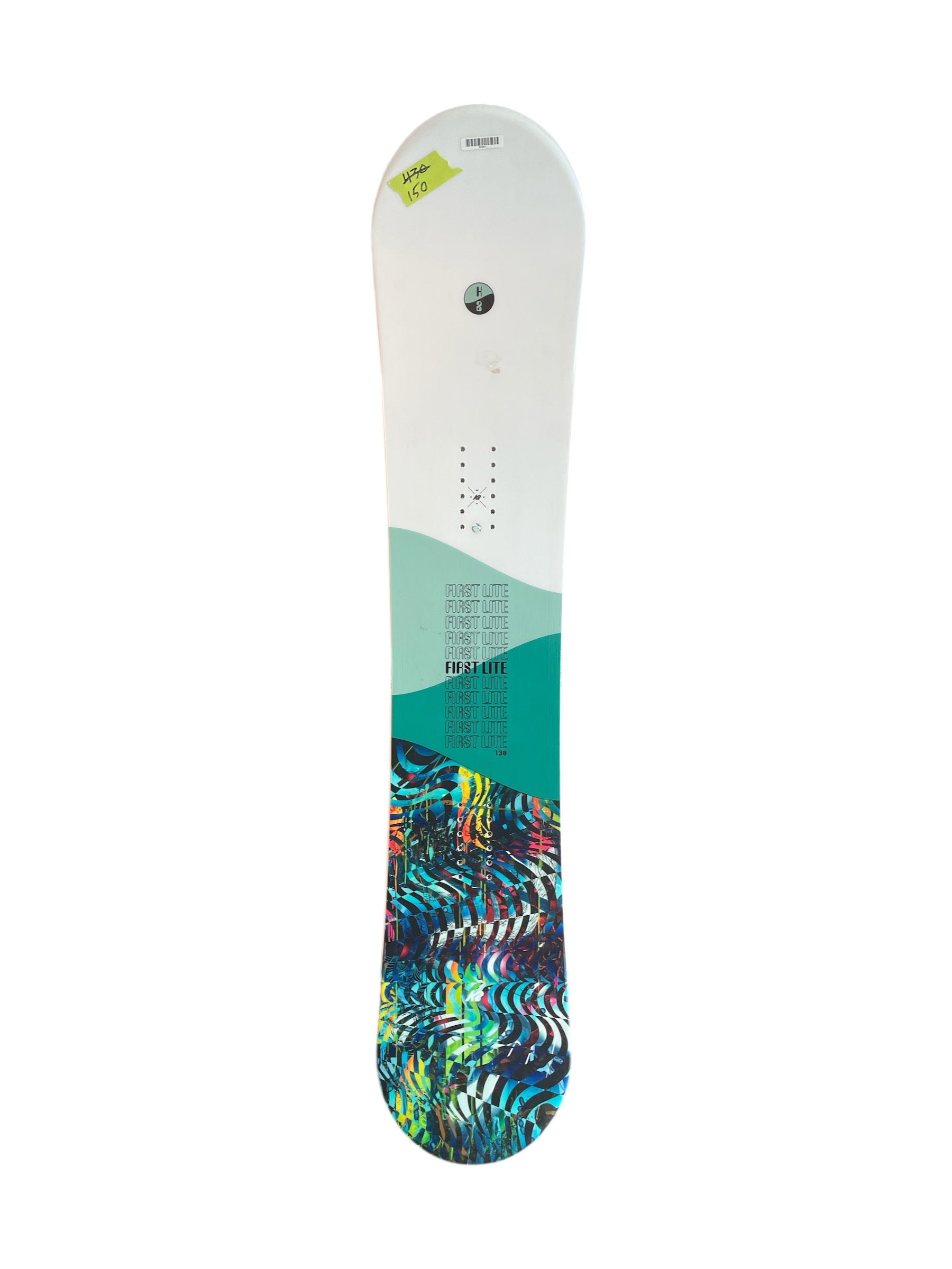 The K2 First Lite Womens Snowboard features a white top, teal midsection, and colorful abstract base. Designed for beginners, it has black mounting holes, text details, and a green 146 sticker near the tip.